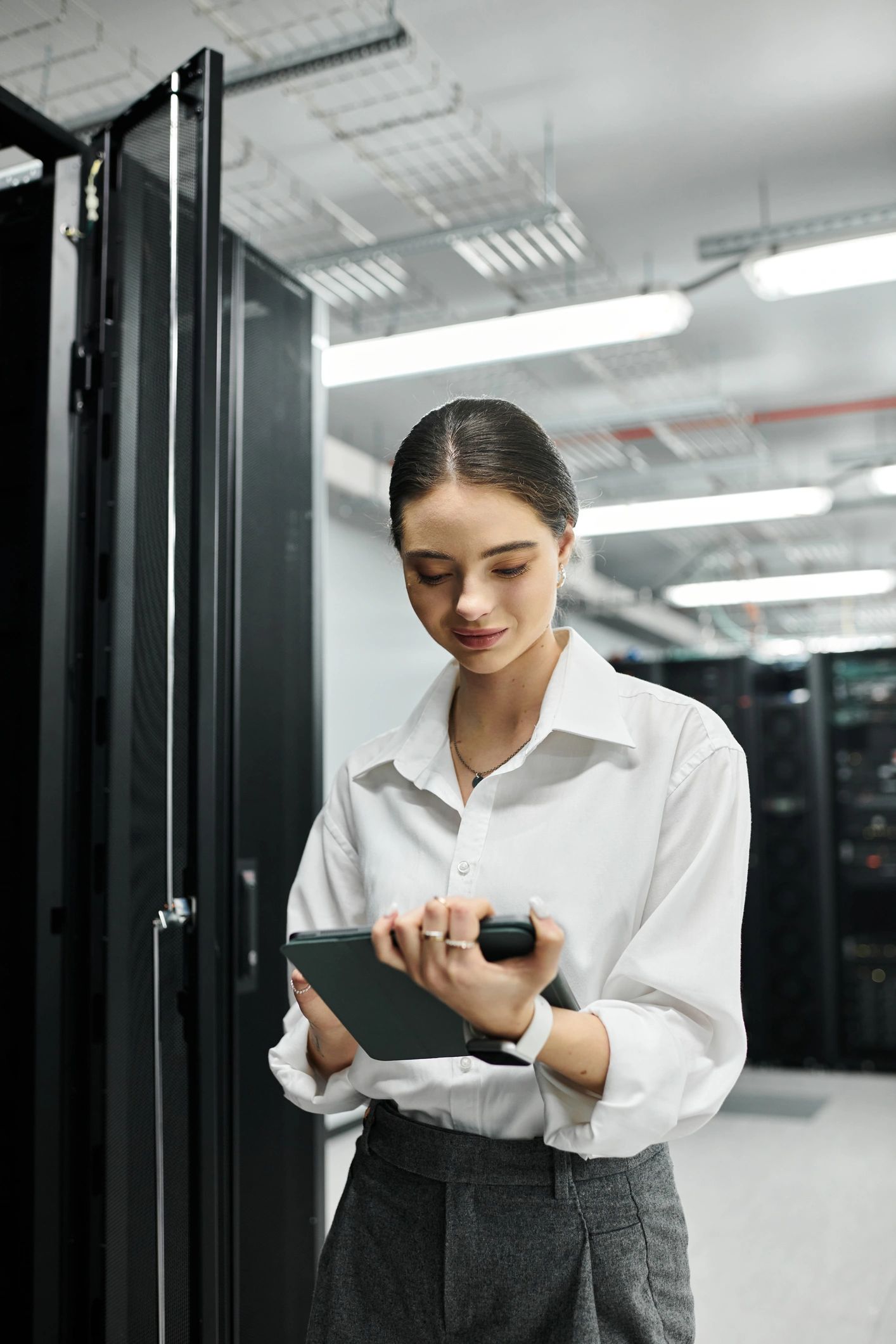 A young IT specialist oversees server maintenance while